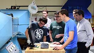 Engineering students working on equipment